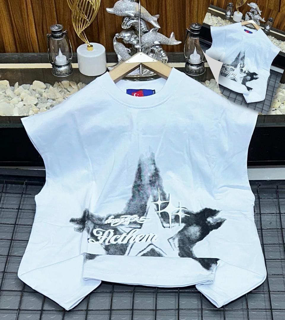 White oversized armless top with star mountain and Anthem graphic print.