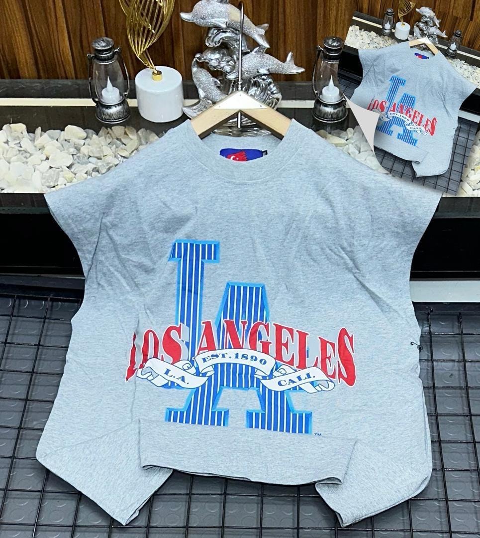 Gray oversized armless top with large Los Angeles graphic print on chest.