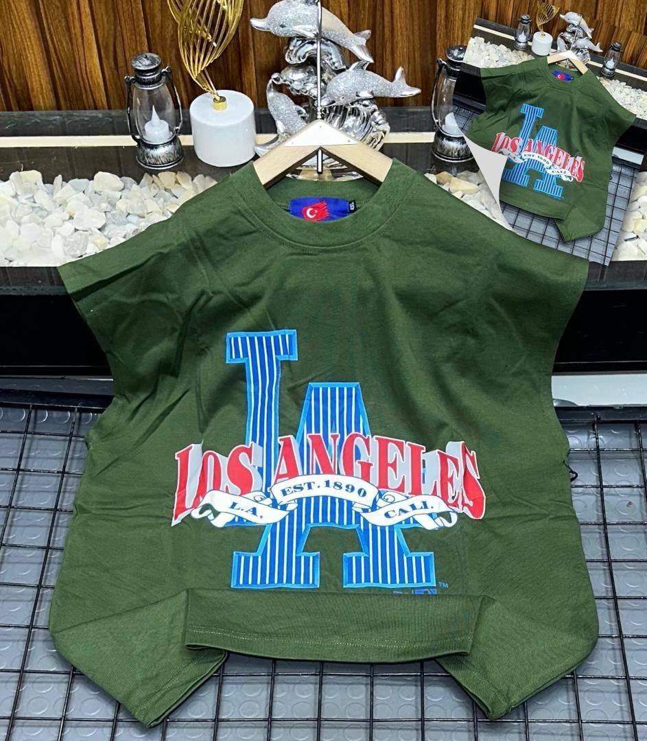 Green oversized armless top with large Los Angeles graphic print on chest.