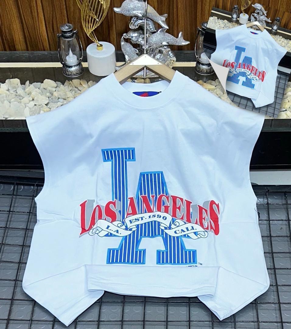 White oversized armless top with large Los Angeles graphic print on chest.