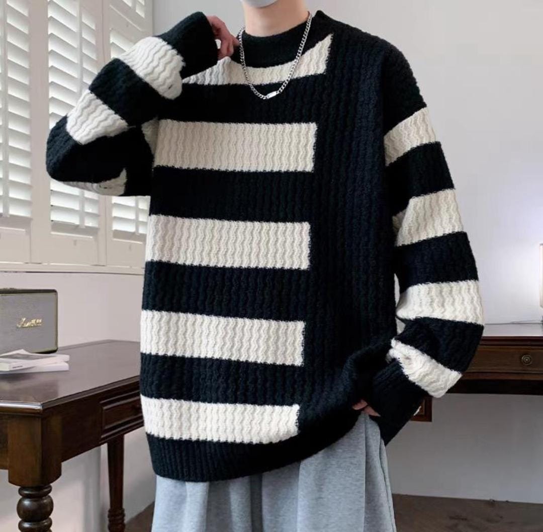 Model wearing black and white striped chunky knit sweatshirt.