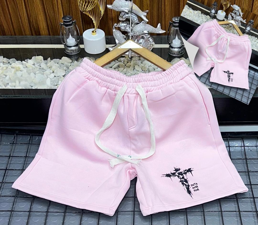 Pink fleece shorts with black cross and Faith Over Fear print.