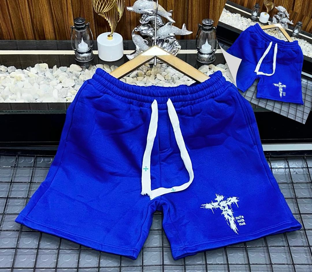 Blue fleece shorts with white cross and Faith Over Fear print.