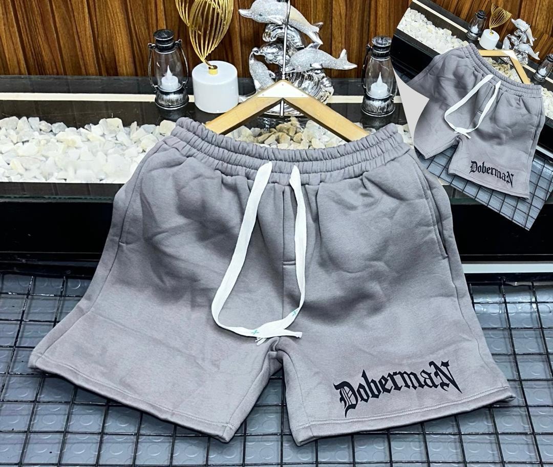 Gray fleece shorts with Doberman gothic print on the leg.