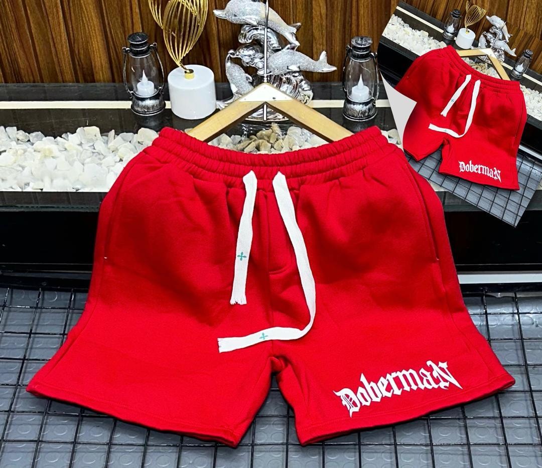 Red fleece shorts with Doberman gothic print on the leg.