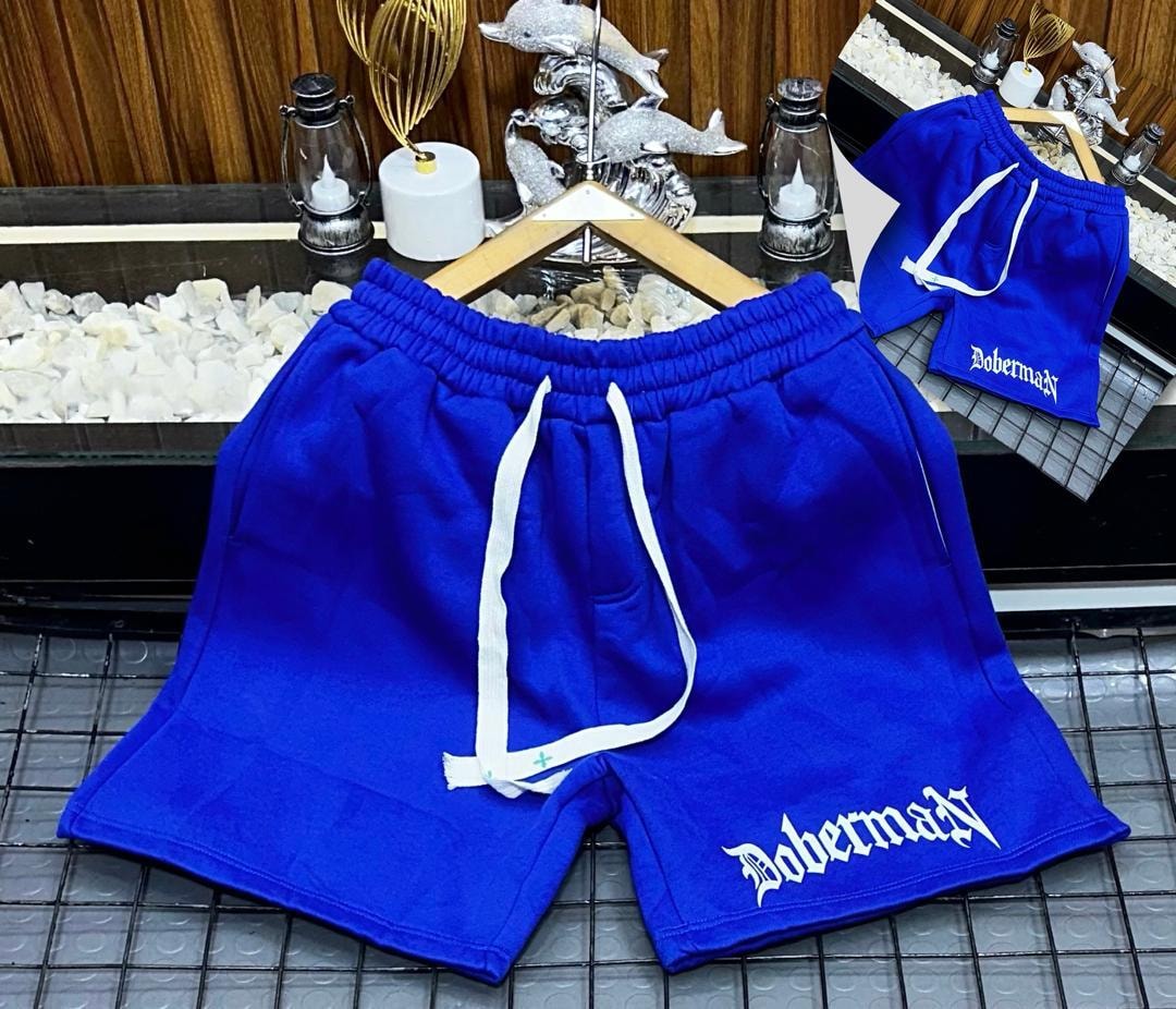 Blue fleece shorts with Doberman gothic print on the leg.