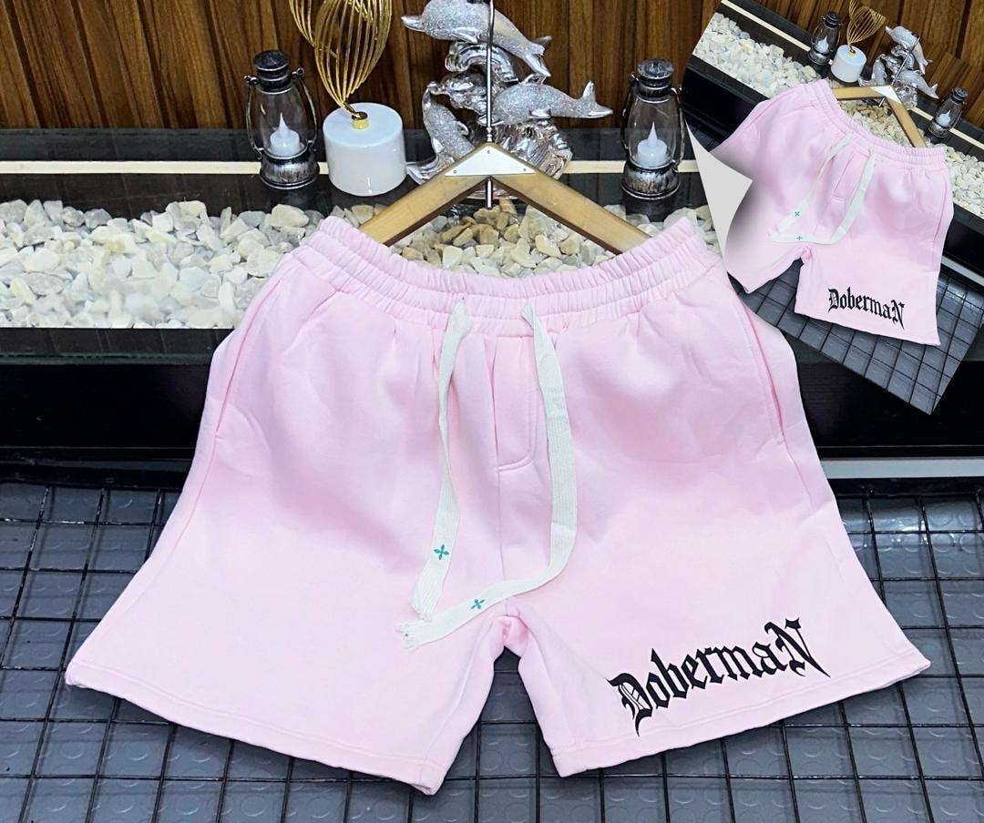 Pink fleece shorts with Doberman gothic print on the leg.