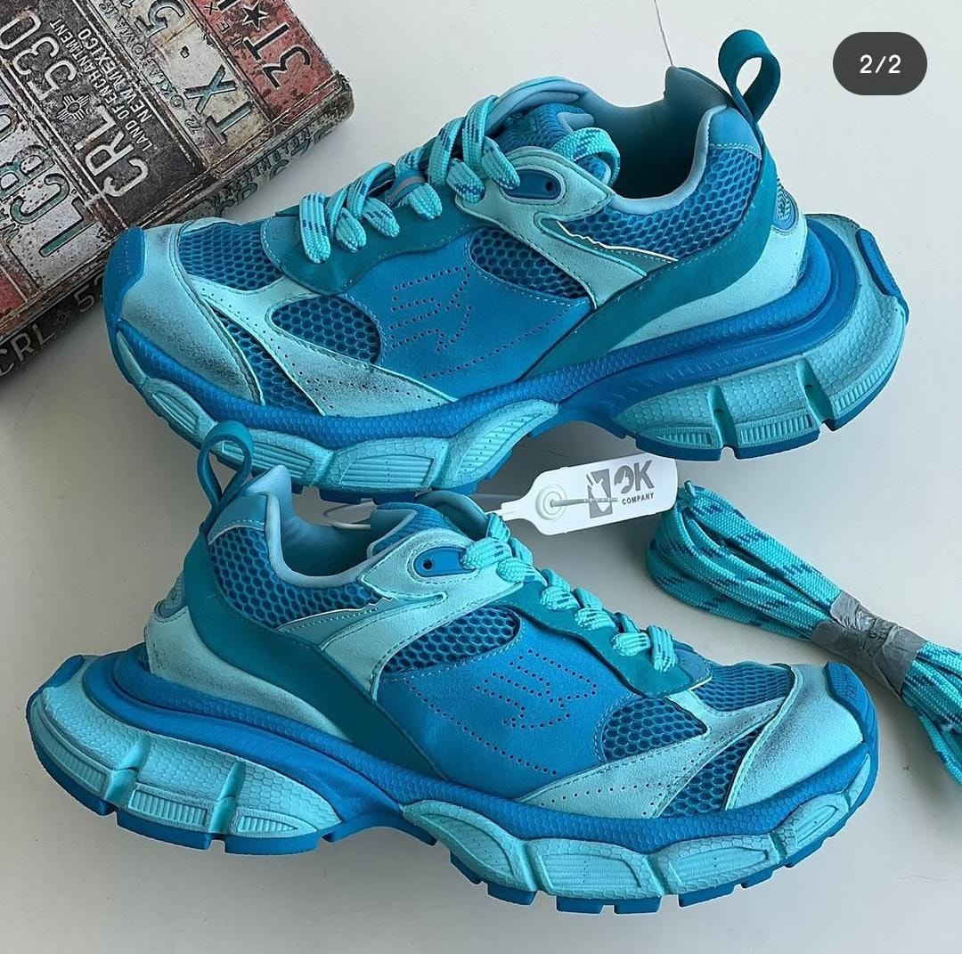 Blue chunky sneakers shown from multiple angles with extra laces and tag.