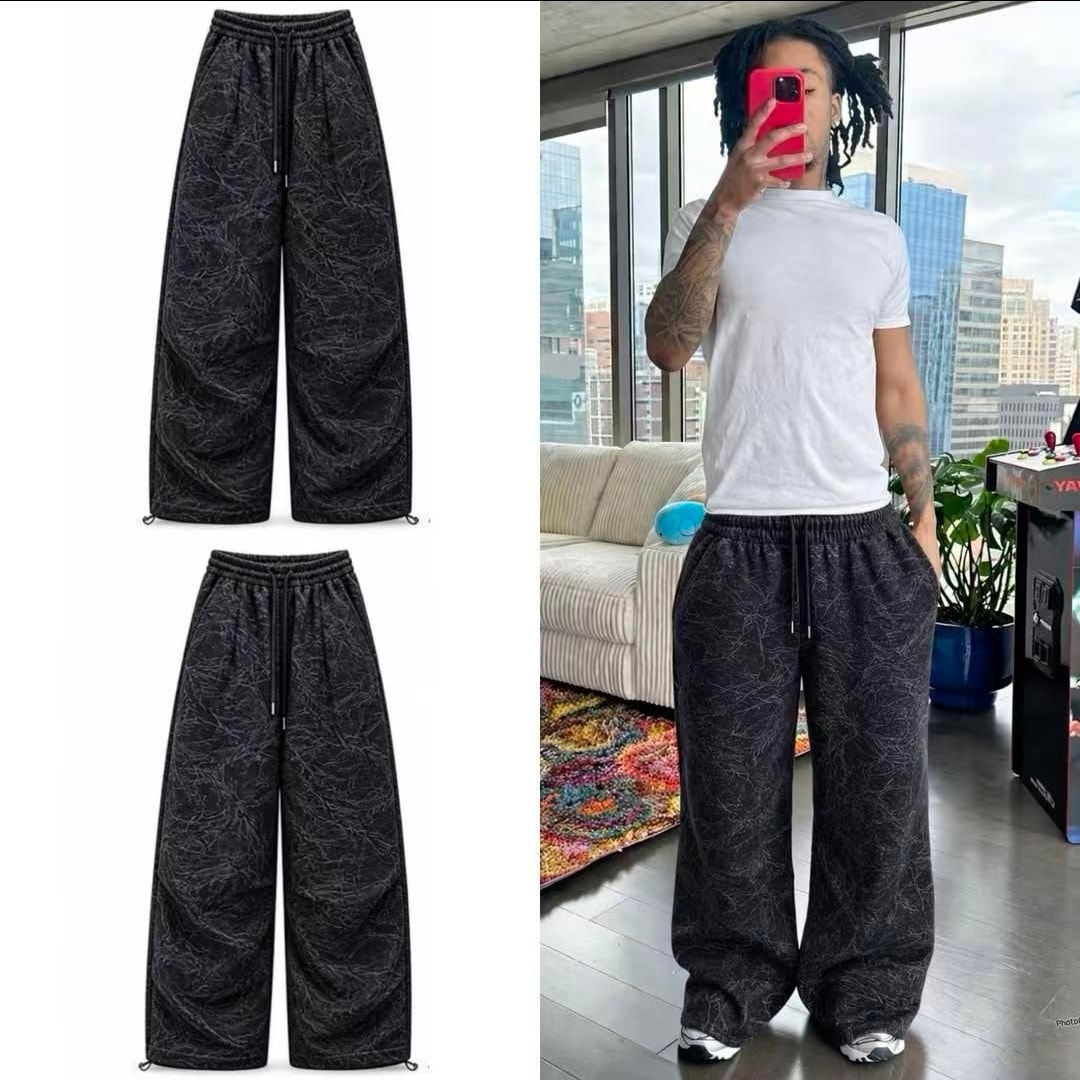 Black marble pattern wide-leg joggers shown in flat lay and worn by model.