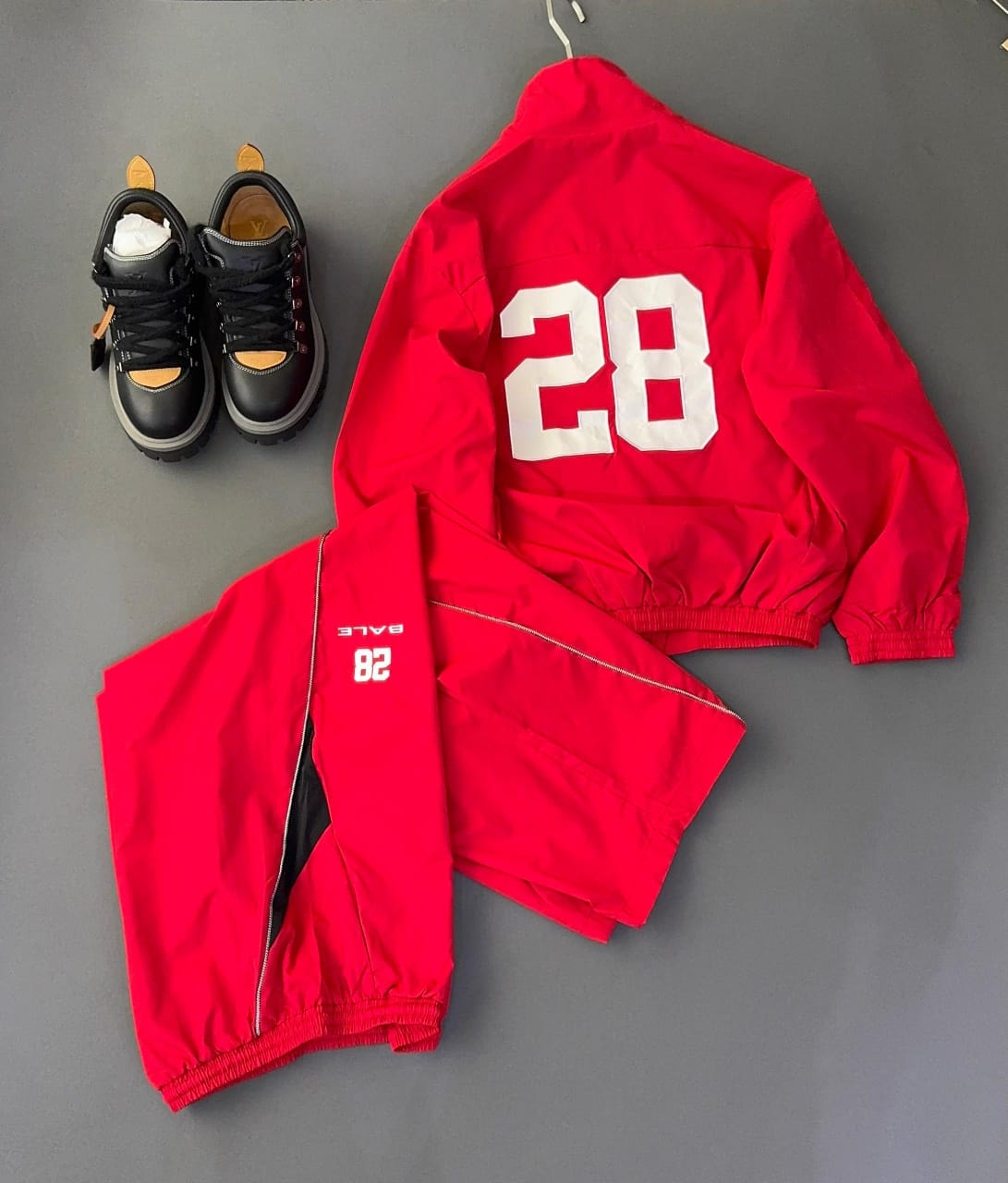 Red Bale two-piece tracksuit back view with prominent white 28 print and black inner lining visible.