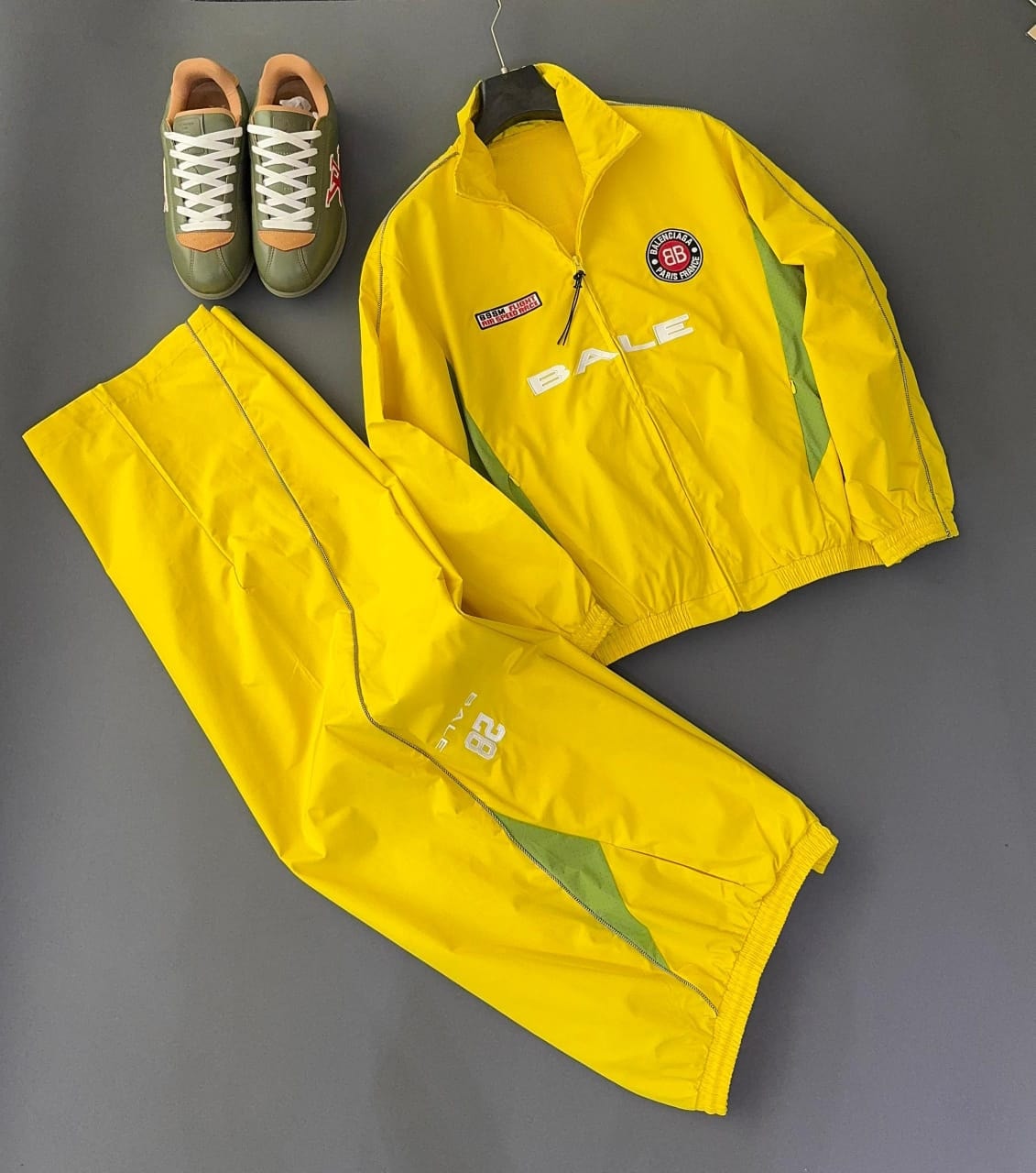 Yellow Bale two-piece tracksuit front view with zip jacket, BALE branding, green accents, and matching yellow pants.
