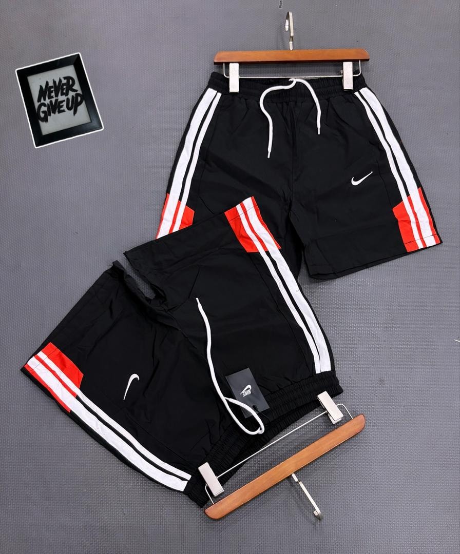 Black Nike striped shorts on hanger and flat lay with tags.