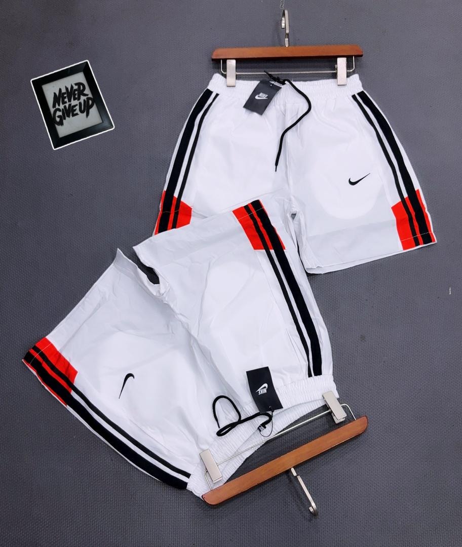 White Nike striped shorts on hanger and flat lay with tags.