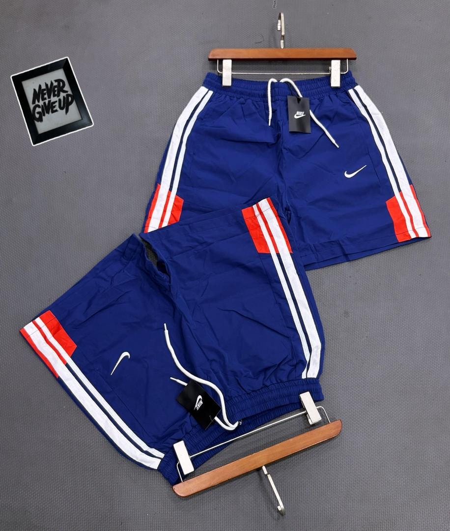 Blue Nike striped shorts on hanger and flat lay with tags.