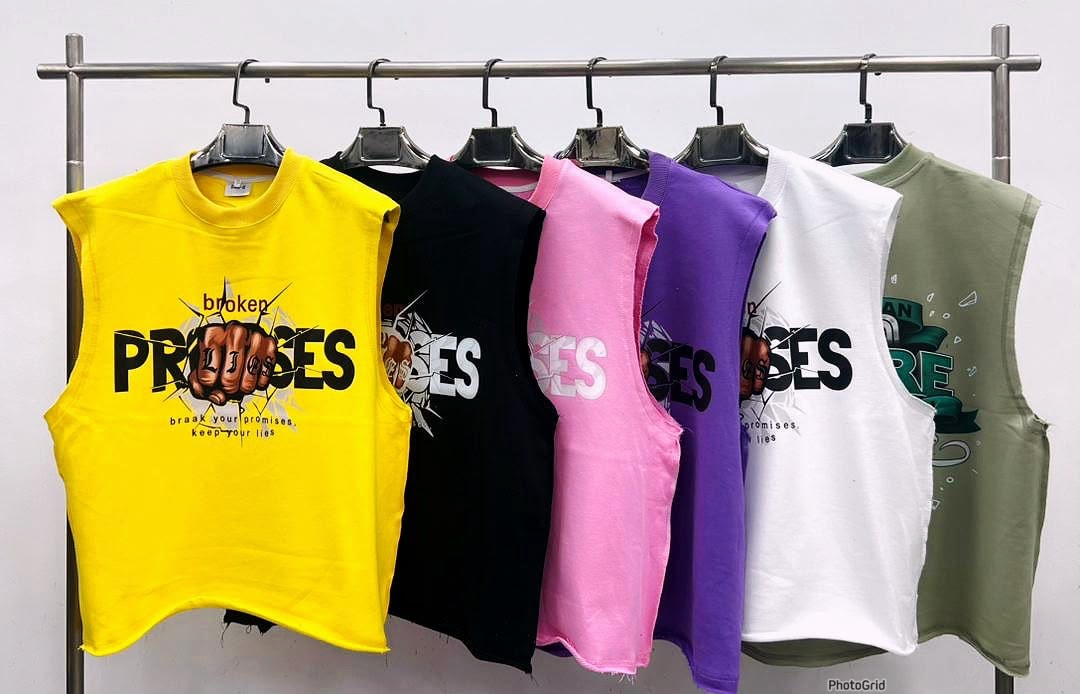 Six cropped armless tees in yellow, black, pink, purple, white and olive with Broken Promises fist graphic.