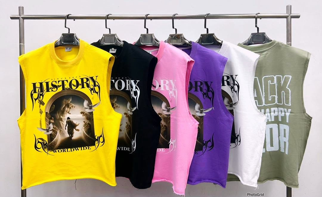 Six cropped armless tees in yellow, black, pink, purple, white and olive with History Worldwide graphic.