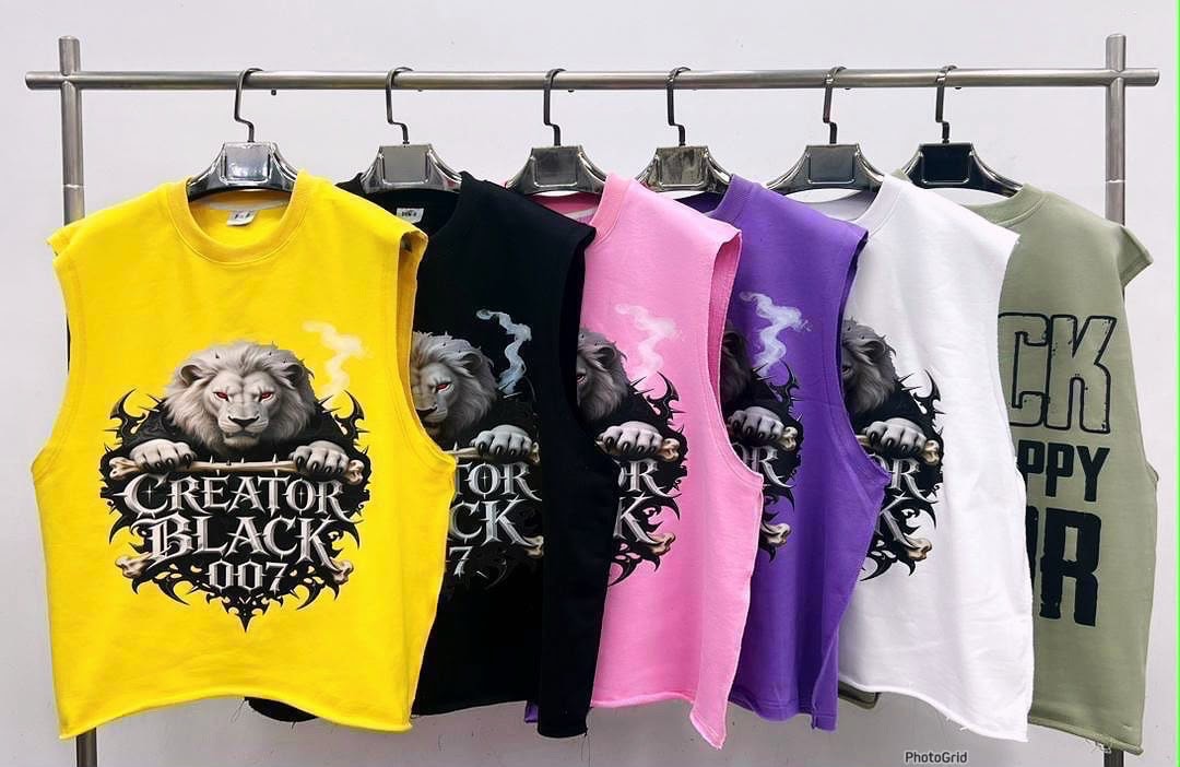 Six cropped armless tees in yellow, black, pink, purple, white and olive with lion Creator Black graphic.