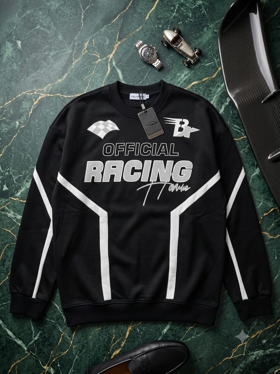 Black sweatshirt with Official Racing print and white stripes on green marble with car props.