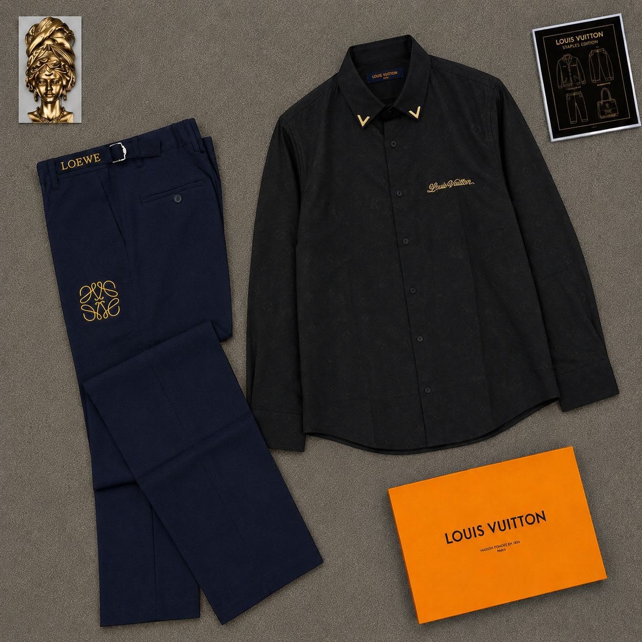 Black monogram Louis Vuitton shirt with navy Loewe embroidered trousers in flat lay.