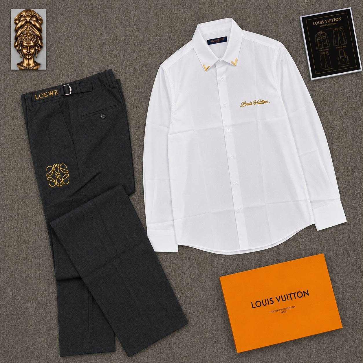 White Louis Vuitton embroidered long-sleeve shirt with black Loewe trousers in flat lay.