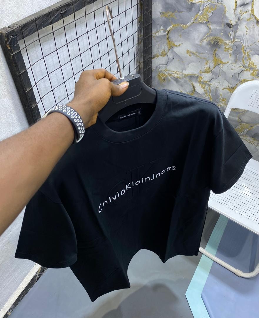 Black t-shirt with Calvin Klein Jeans style print on chest.