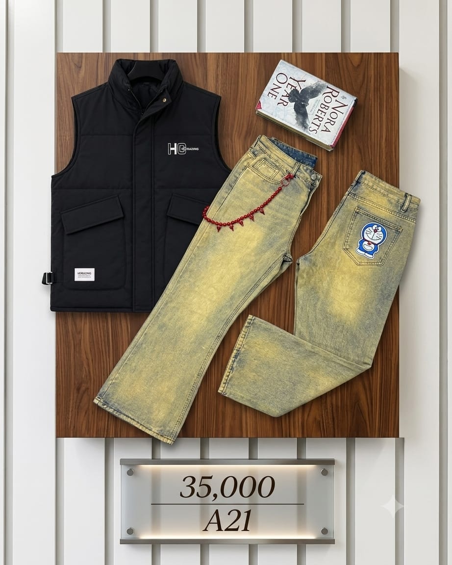 Black puffer vest with HG Brazing logo and yellow acid wash jeans with Doraemon patch and red chain on wooden surface.