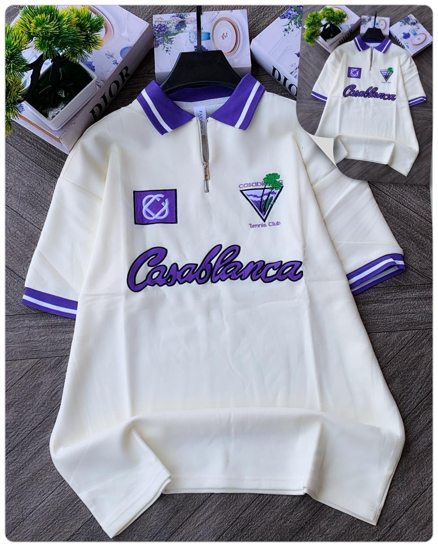 Cream Casablanca tennis club quarter zip polo with purple details.