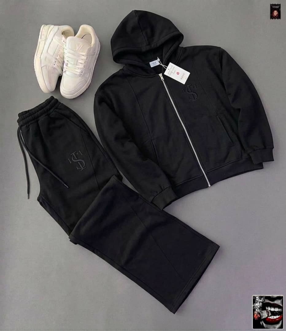 Black zip-up hoodie and pants with embroidered logo, shown with white sneakers.