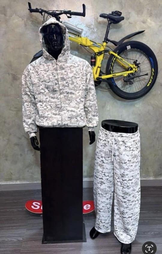 Mannequin displaying gray digital camouflage zip-up hoodie with hood down and coordinating wide-leg pants.