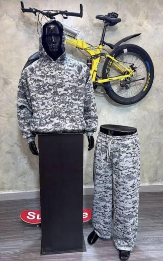 Mannequin wearing gray digital camouflage zip-up hooded jacket with hood up and matching pants.