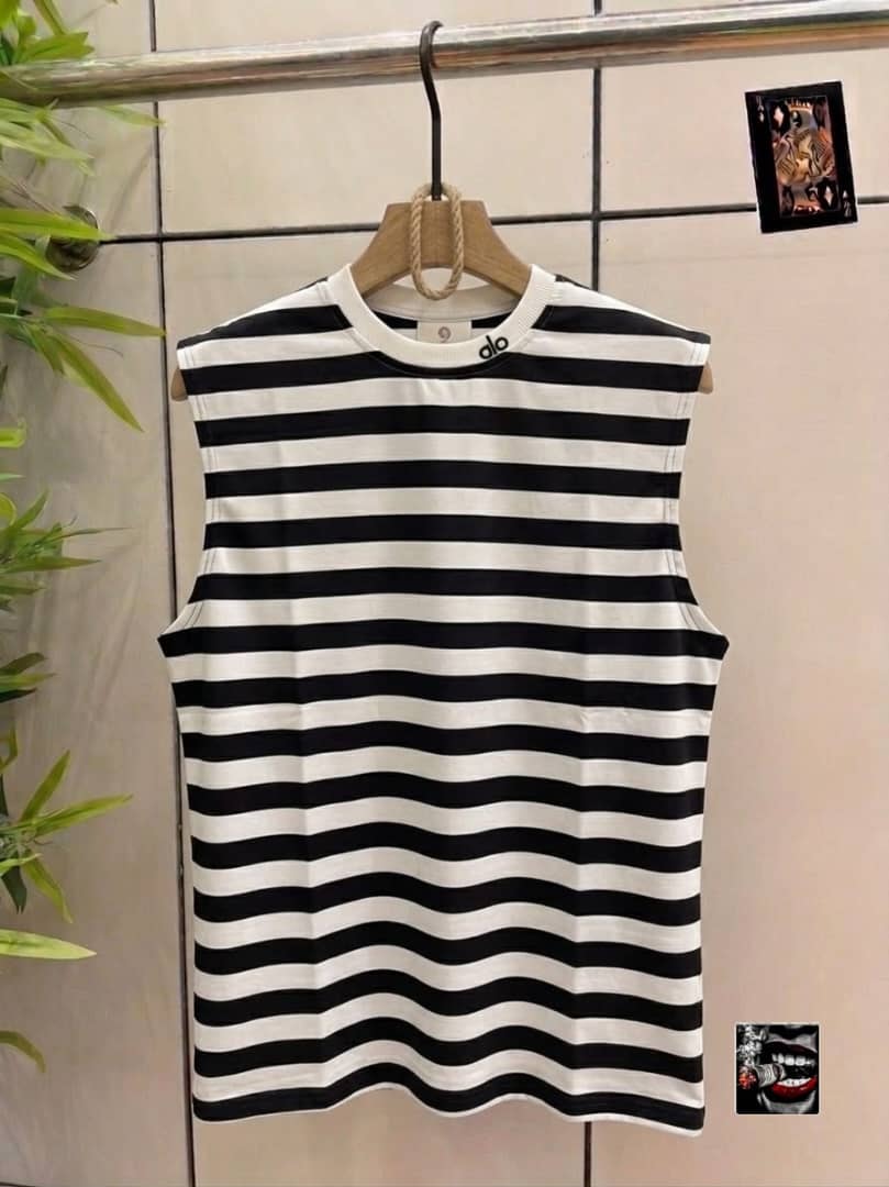Black and white striped sleeveless top with alo neck detail.