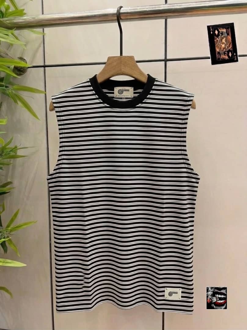 Black and white striped sleeveless top with small hem tag.