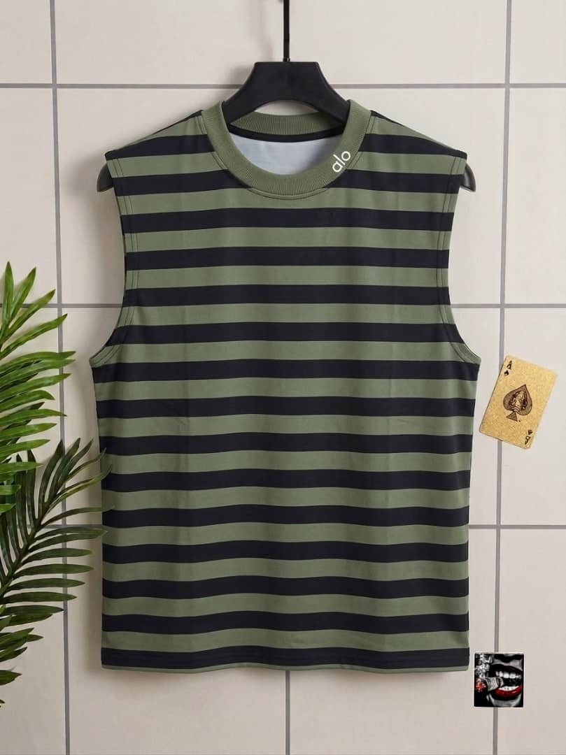 Green and black striped sleeveless top with alo neck detail.