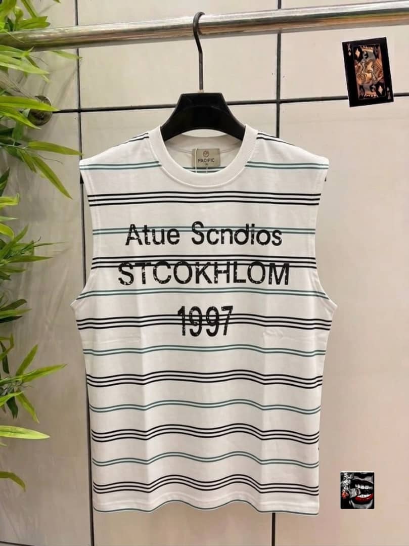 White and green striped sleeveless top with Atue Scndios Stockholm 1997 chest print.