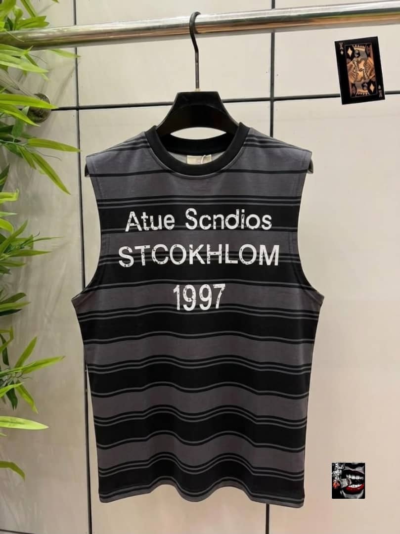 Gray and black striped sleeveless top with Atue Scndios Stockholm 1997 chest print.
