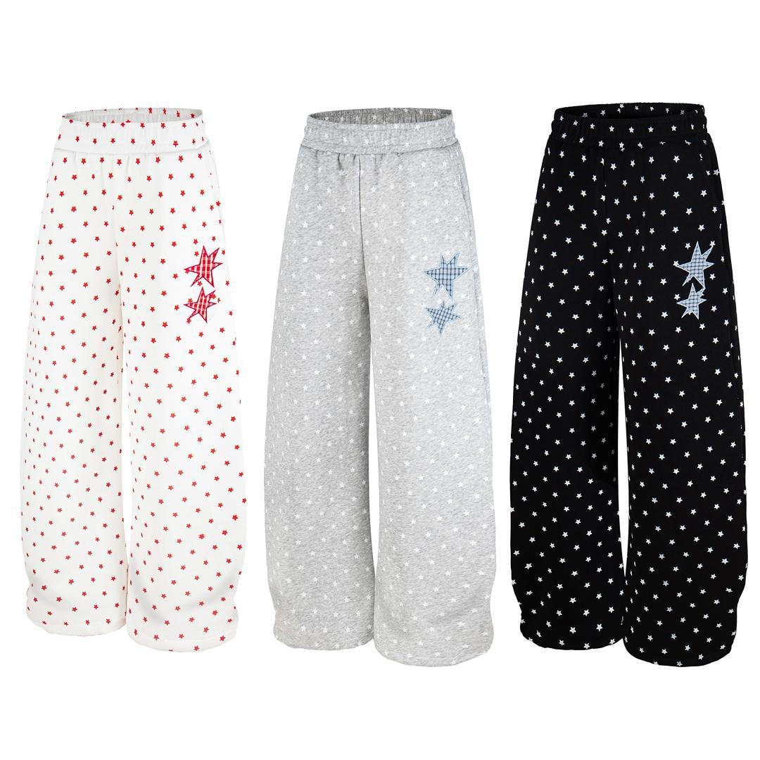 Three star-patterned joggers in white with red stars, gray, and black shown side by side.