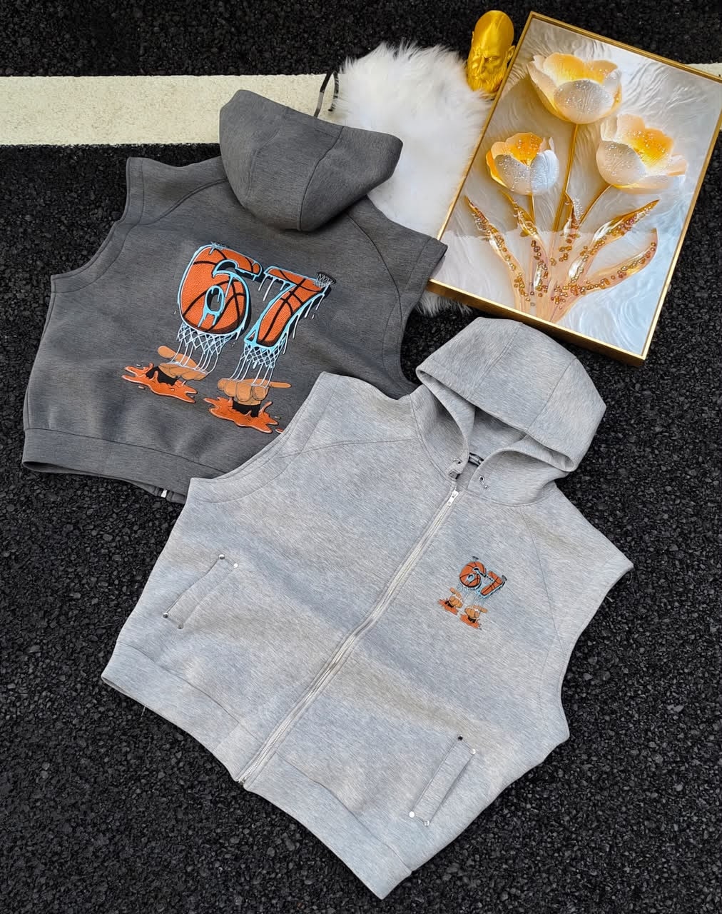 Sleeveless hoodies with 67 basketball graphic in gray shades with golden decor and white fur.