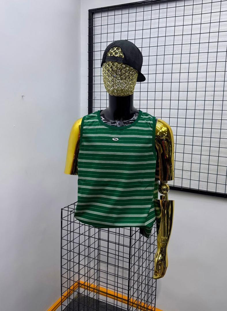 Green and white striped armless tank top displayed on a mannequin with cap.
