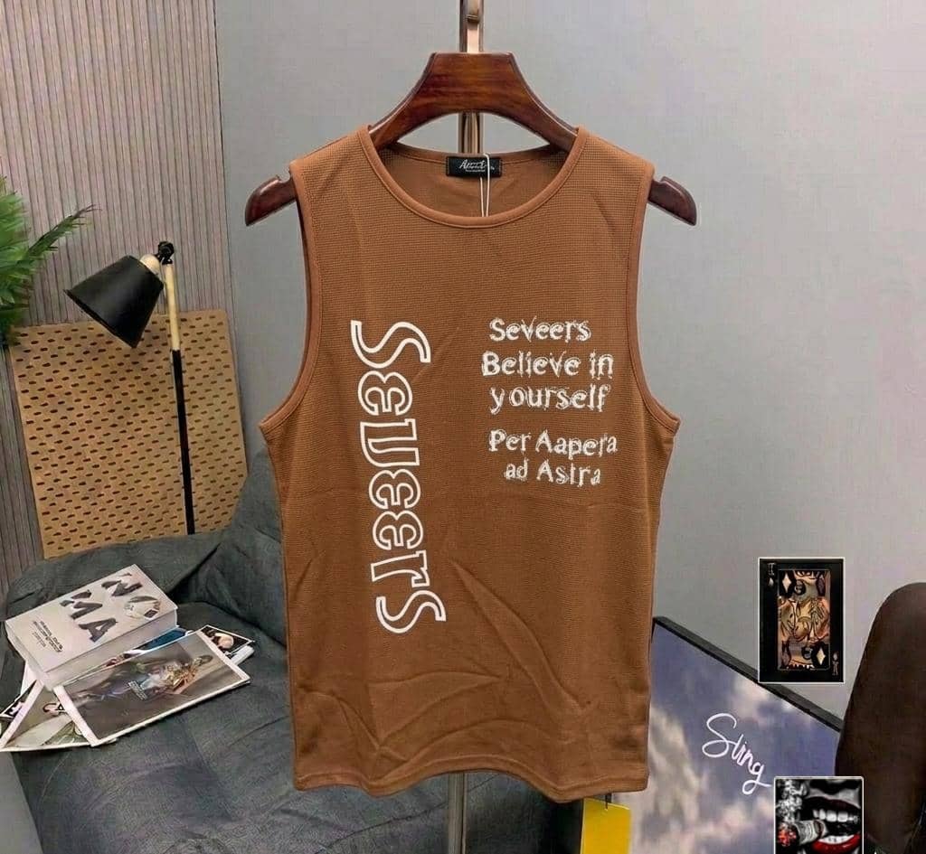 Brown armless tank top with white motivational text prints displayed on a wooden hanger.
