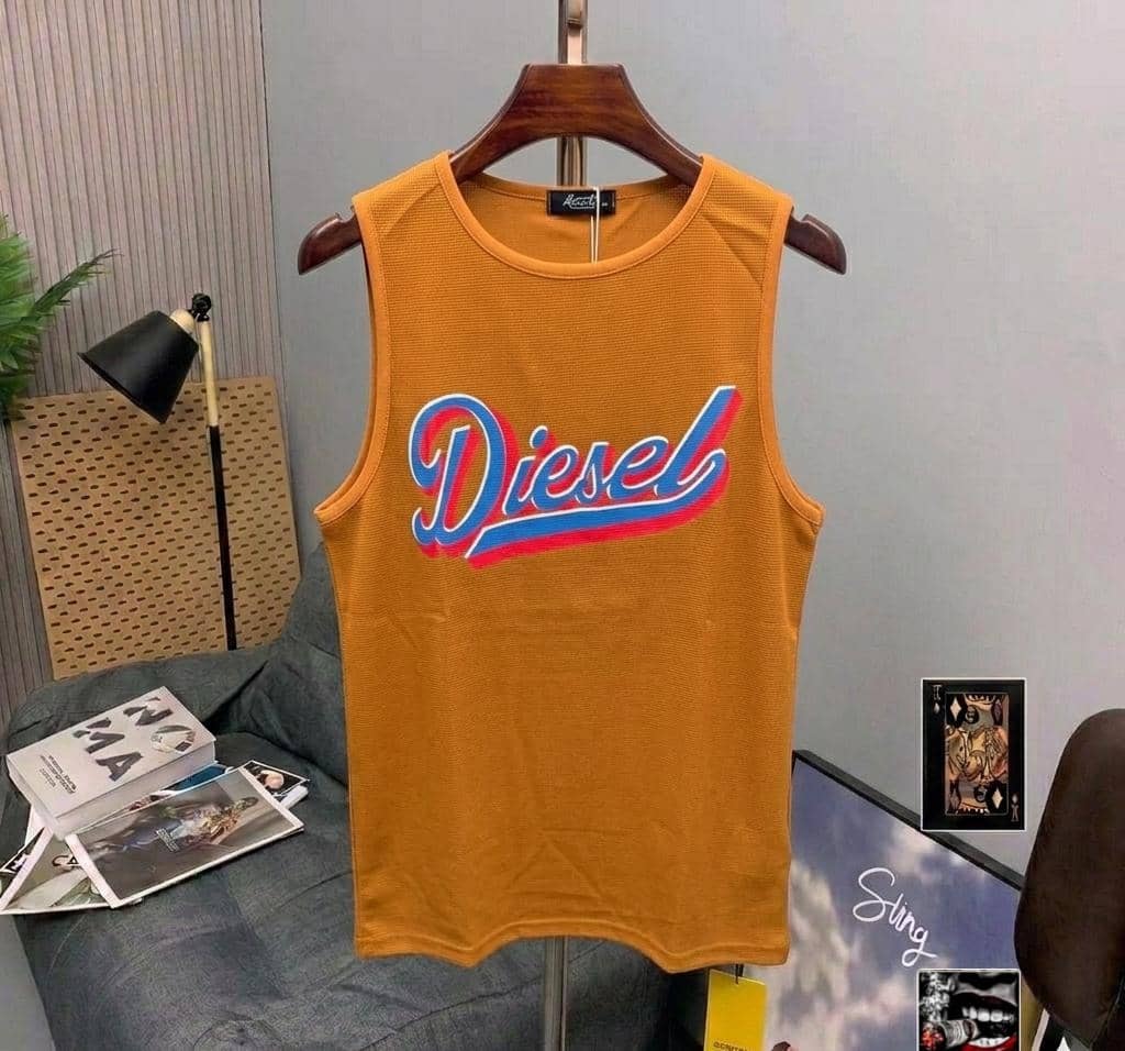 Orange ribbed armless top with Diesel script logo.