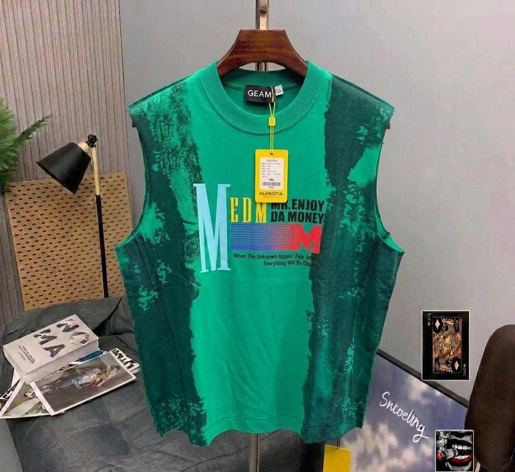 Green tie-dye armless top with MEDM graphic print.