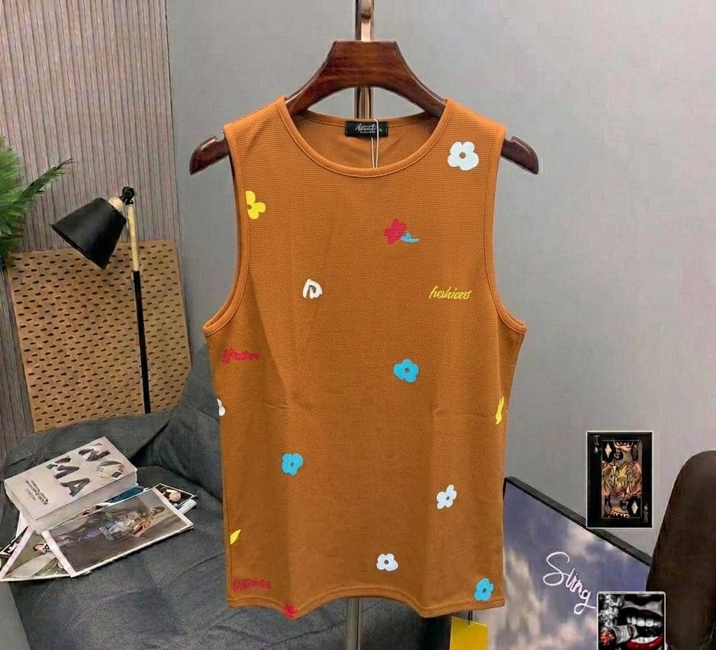 Mustard ribbed armless top with colorful flower and butterfly prints.