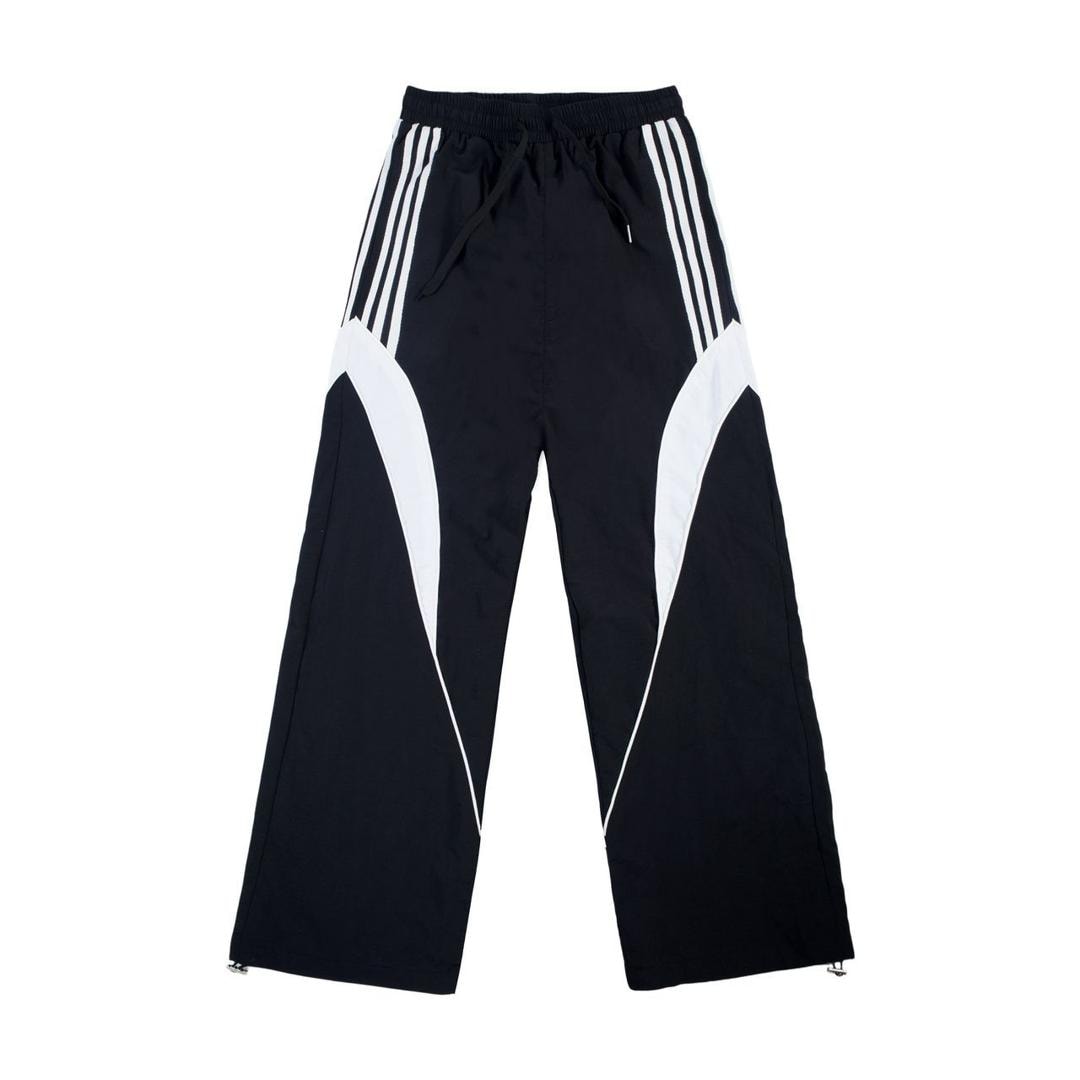 Black joggers with white contrast panels and white side stripes.