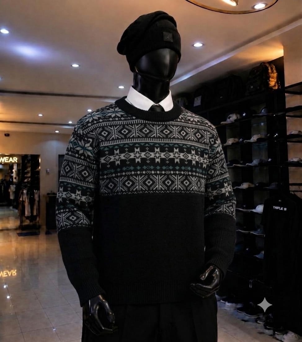 Mannequin wearing black fair isle patterned knit sweatshirt with snowflake design and black beanie.