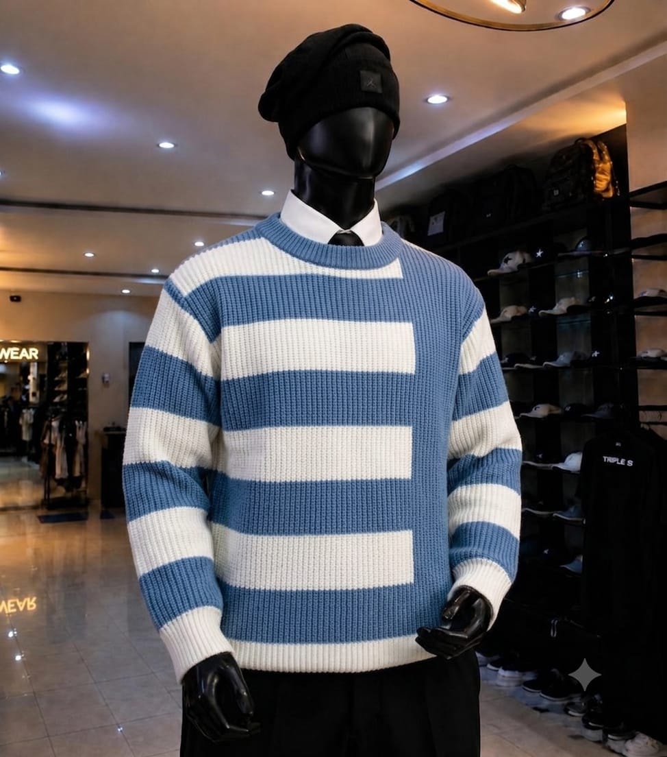 Mannequin wearing blue and white striped knit sweatshirt with black beanie and white collared shirt.