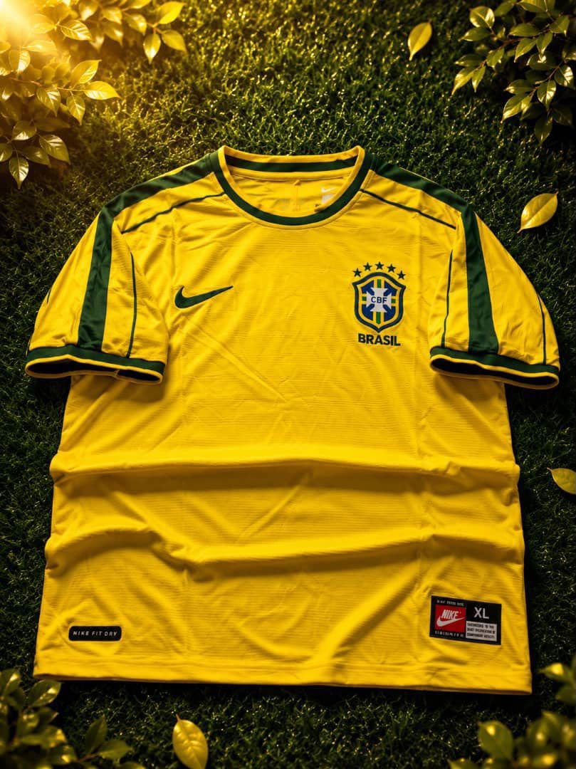 Yellow Nike Brazil national team home jersey laid flat on grass.