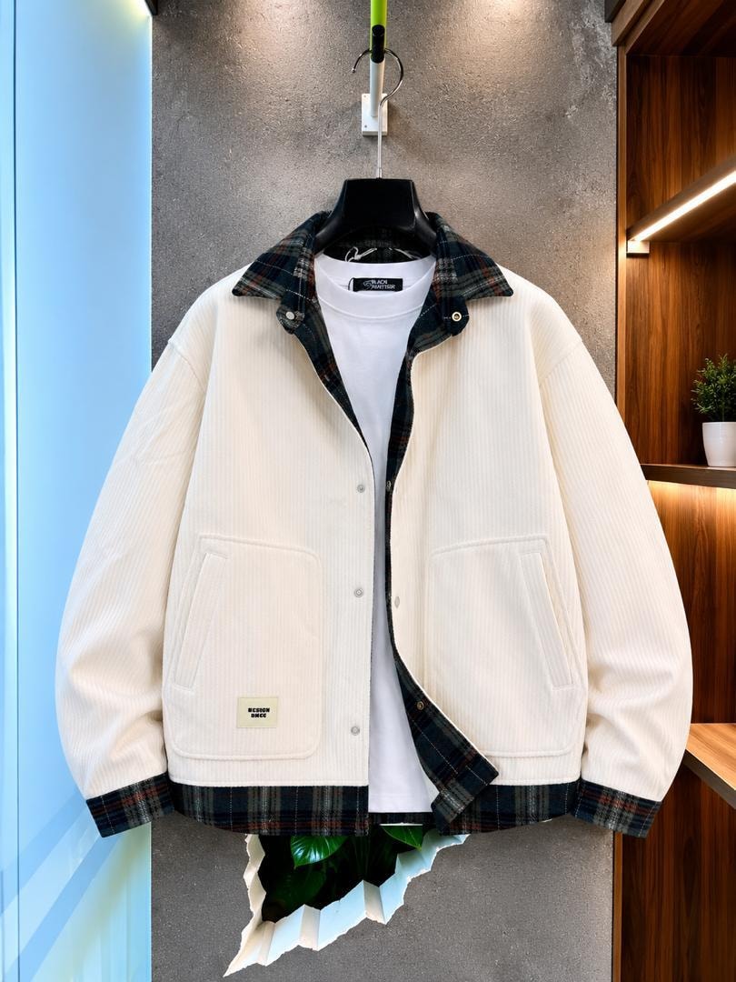 Cream corduroy jacket with plaid trim hanging open over white tee.