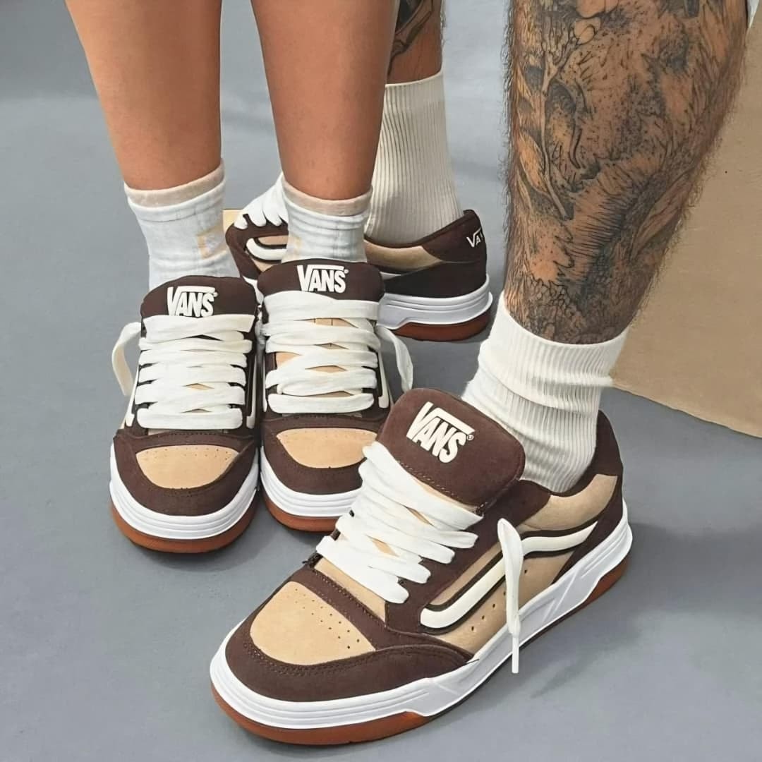 Brown and beige Vans low sneakers worn by two people.