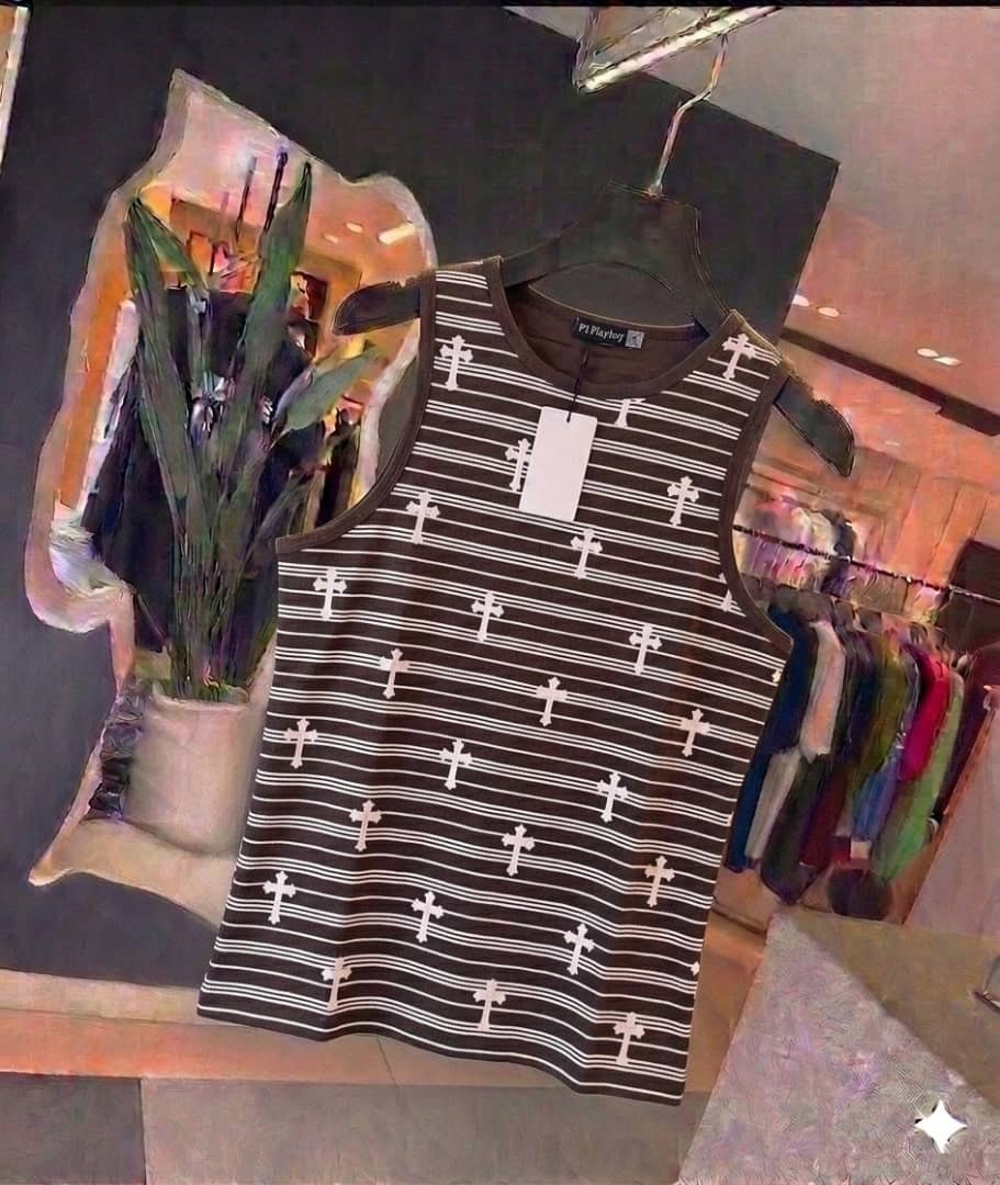 Striped black and white cross pattern tank top hanging in retail setting.