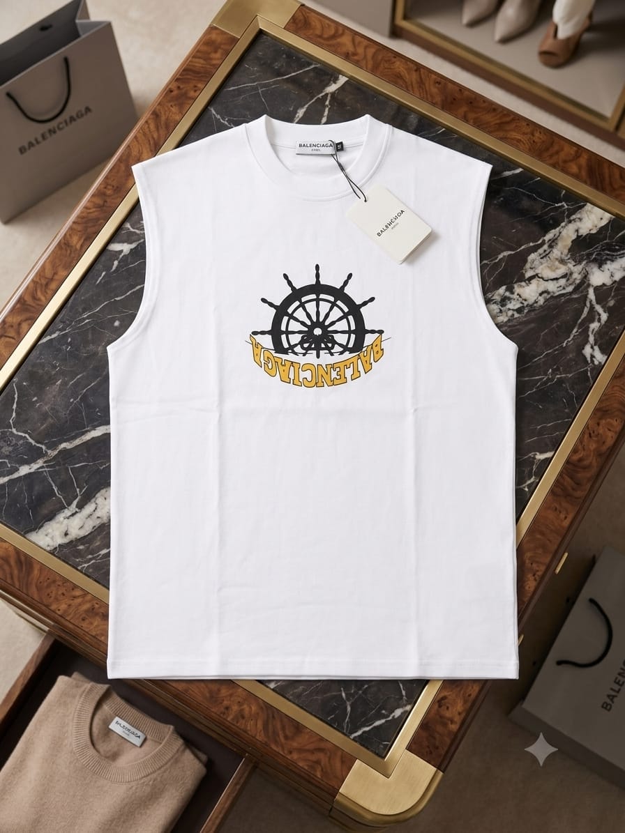 White Balenciaga sleeveless t-shirt with ship wheel graphic on dark marble table.